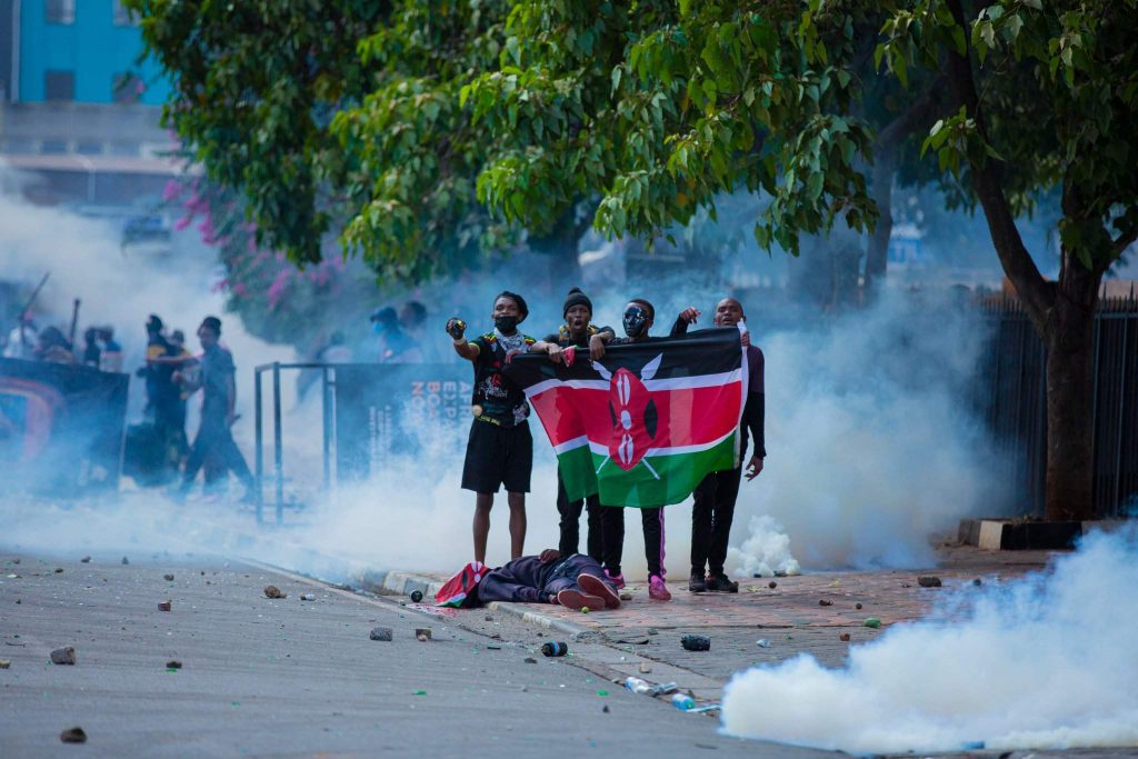 Kenyan youth next to a body during Gen Z Protest